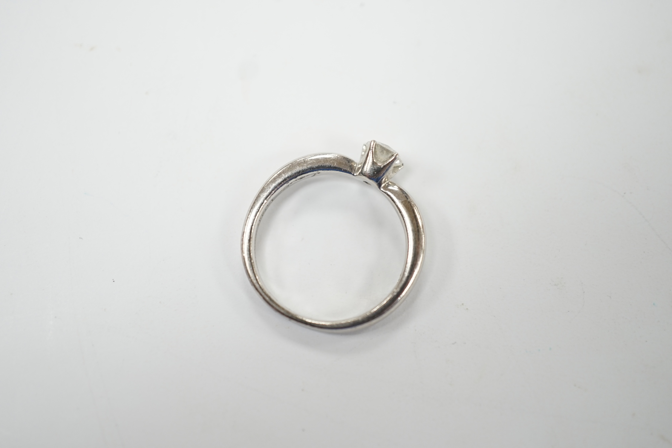 A modern white metal (stamped PT950) and solitaire diamond set ring, size H/I, gross weight 3.8 grams. Good condition.